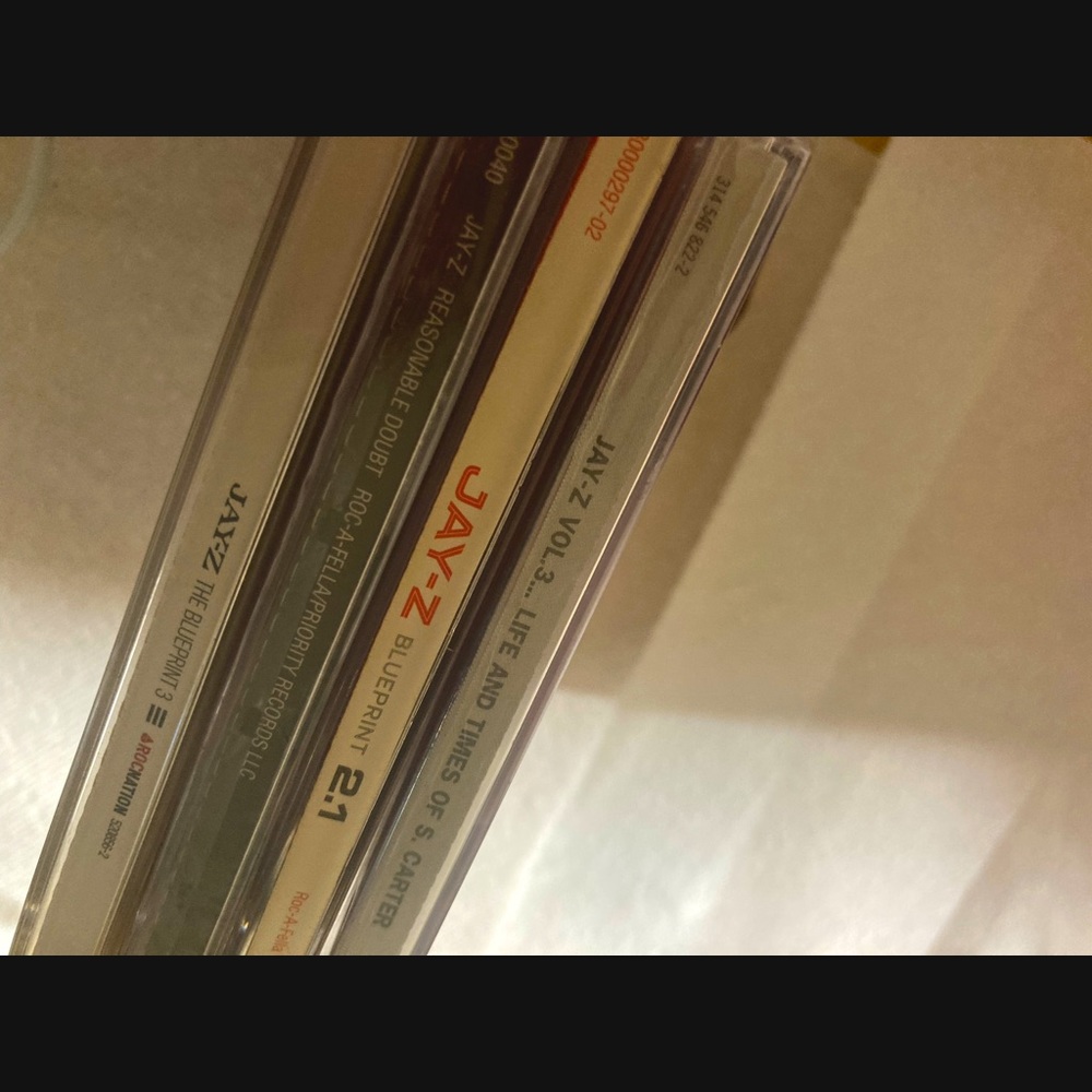 Four Jay-Z albums. Two unopened brand new in original cases. Two slightly used